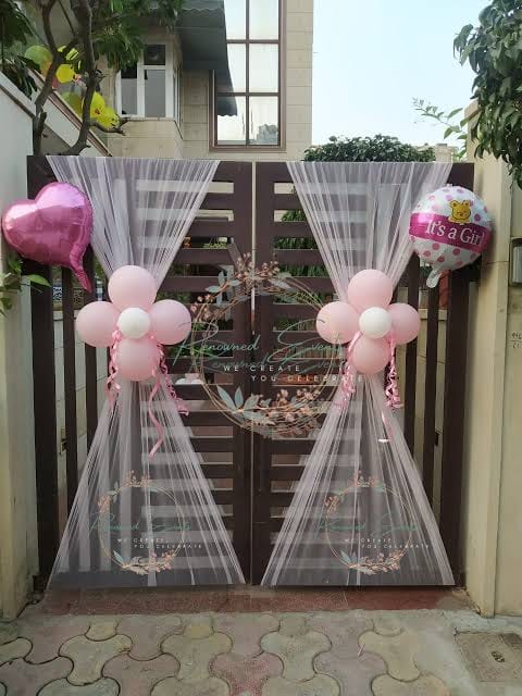 Welcome baby girl gate decoration with pink balloons and net drapes